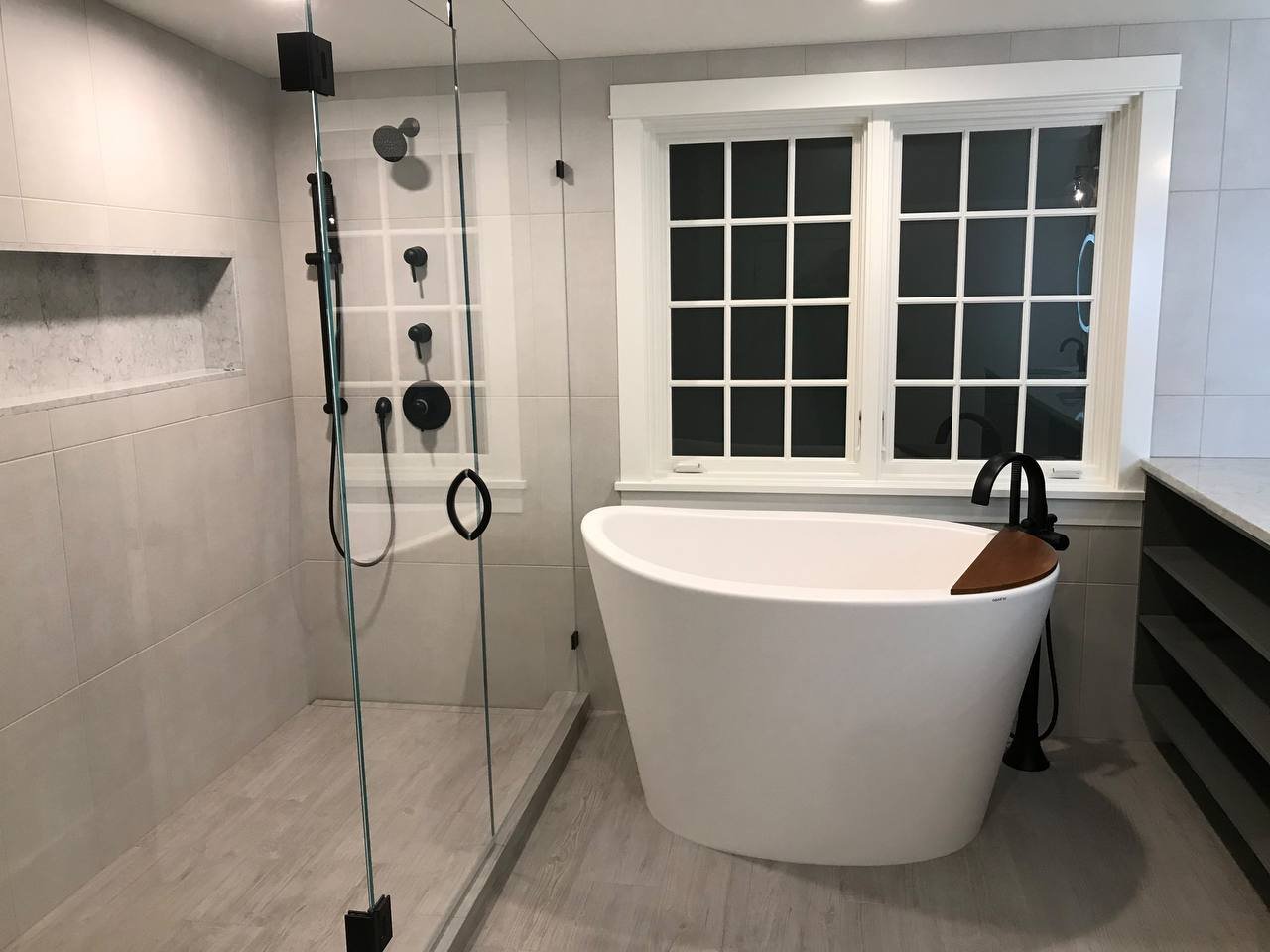 Freestanding soaking tub with matte black fixtures, Sapphire Remodeling bathroom project